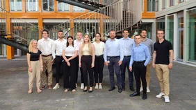 A group of people in front of a modern building.